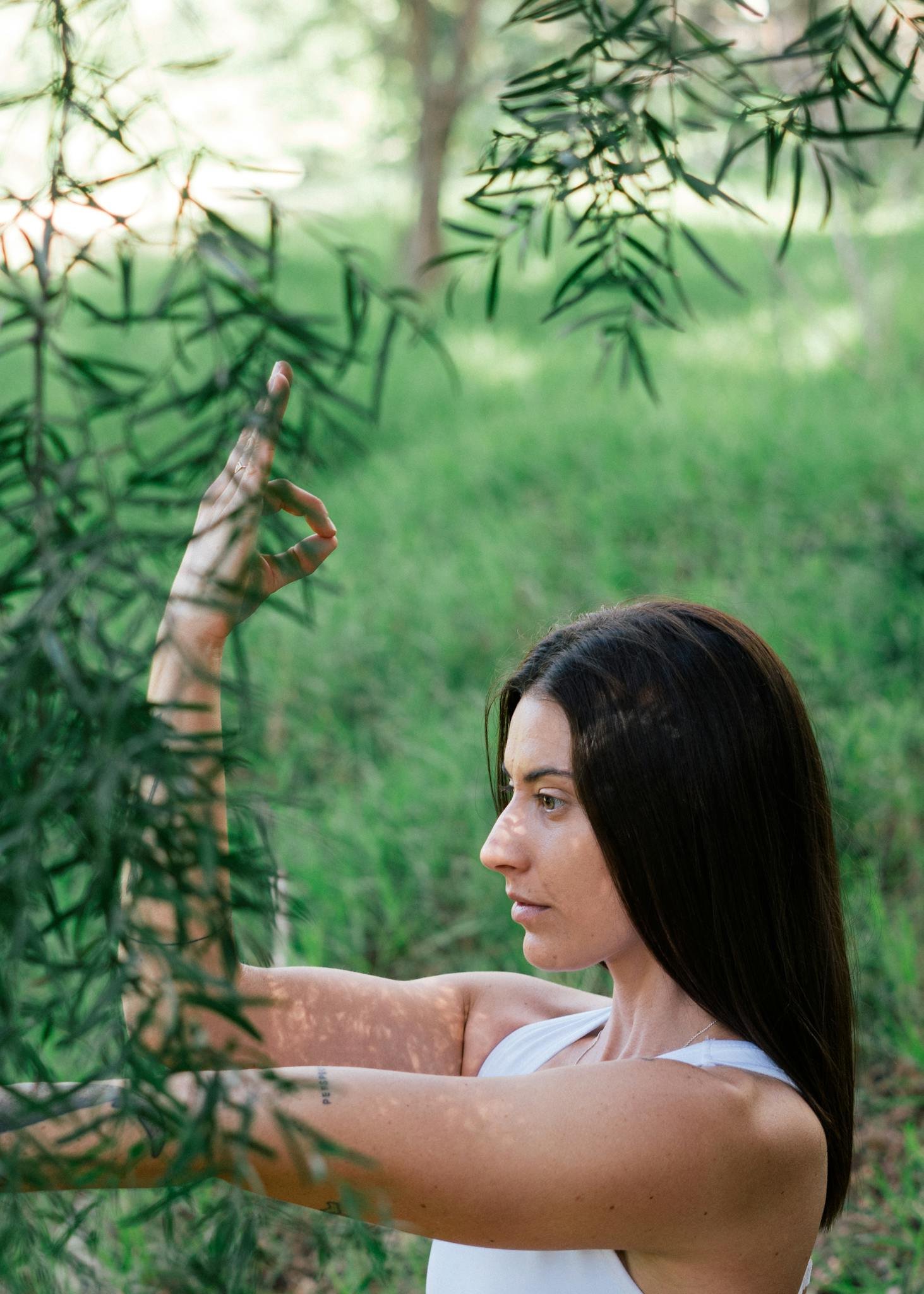 Serene woman practicing yoga in forest